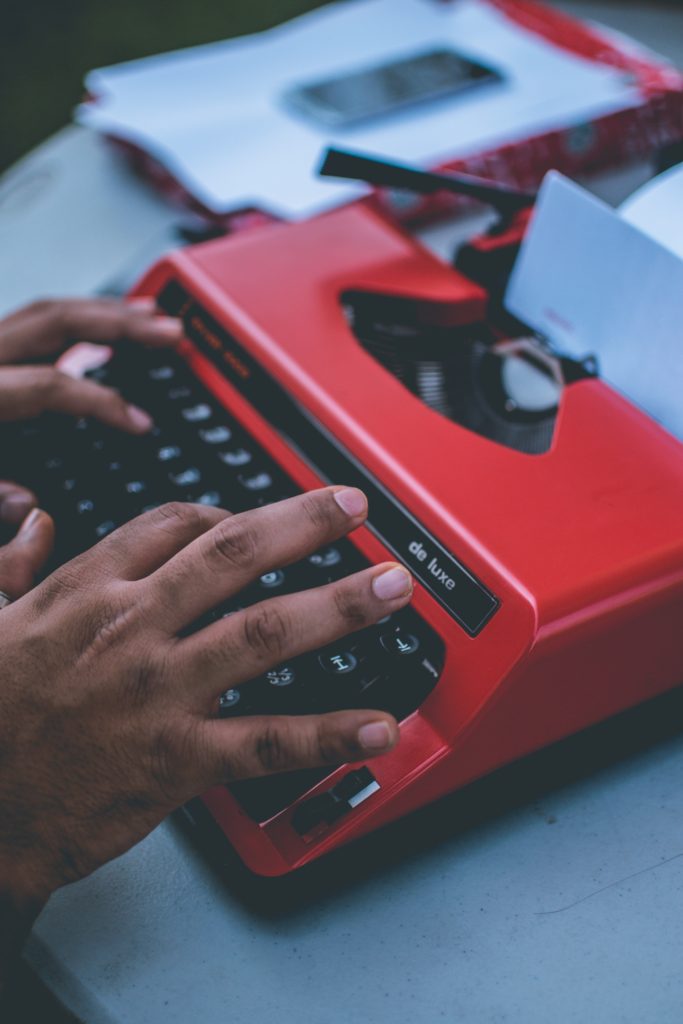 Hands on Red Typewriter